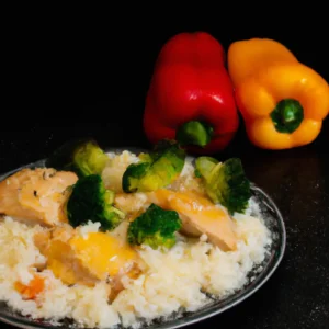 cheesy-chicken-with-rise-and-cut-bell-peppers-and-a-litle-cut-broccoli-on-a-dark-table